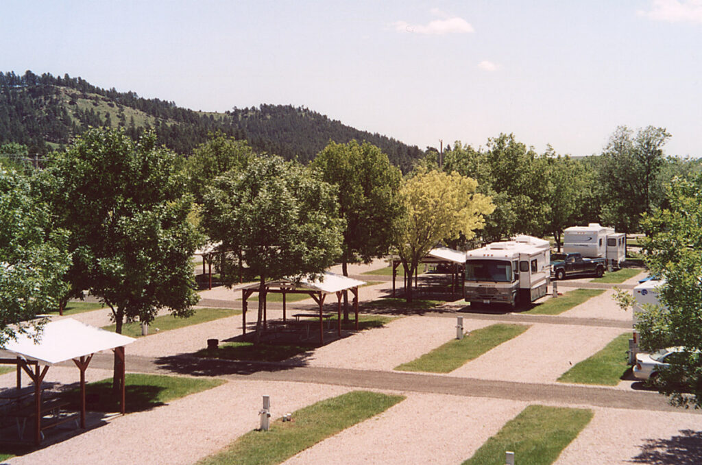 Full hook up pull through and back in RV sites with individual pavilions and shade trees at Happy Holiday RV Resort in Rapid City Black Hills of South Dakota